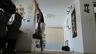 Man sets personal record for a PIN—a one-finger handstand