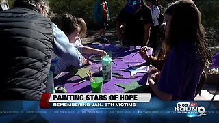 Community and families paint stars of hope to remember victims of Jan. 8 shooting