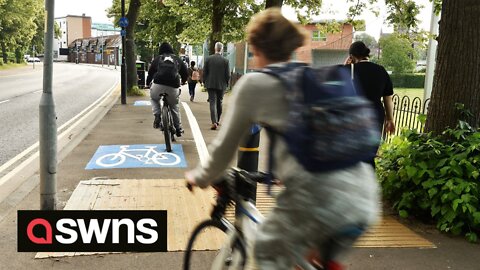 UK council build cycle lane littered with a speed camera, rubbish bins, trees and lampposts