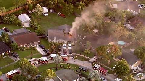 Firefighters battle house fire in suburban Lake Worth