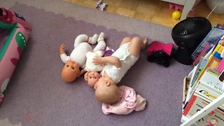 Adorable Baby Plays With Baby Dolls