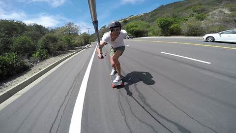 Daredevil skateboards down hill at insanely high speeds