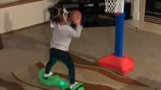 Three-year-old on hoverboard does amazing basketball trick!