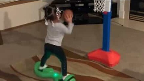 Three-year-old on hoverboard does amazing basketball trick!