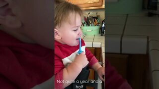 Baby brushes his teeth