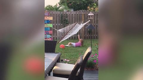 Tot Girl Tries To Get On A Hammock, But It Flips Over And Over Again