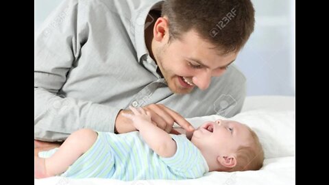 A Father is Playing with His Son in the Bed