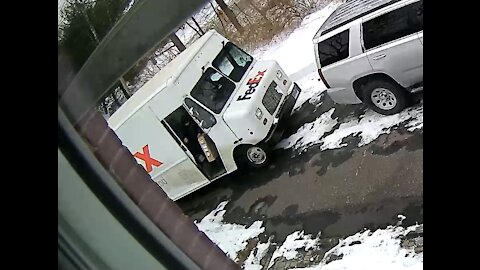 FedEx delivery crew stops and drops and rolls a 50 pound box onto the wrong driveway