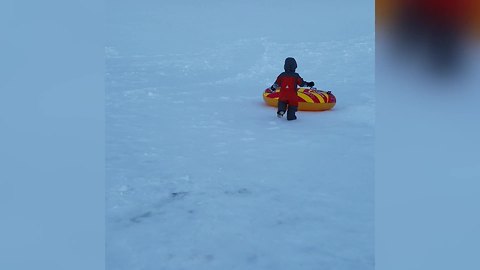 "Tot Boy Having Fun on A Snow-Covered Hill"