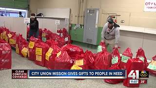 Volunteers help City Union Mission deliver food and presents to needy