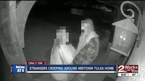 Woman catches strangers snooping around home