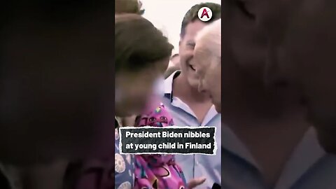 President Biden nibbles at young child in Finland
