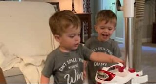 Twins suck up laughter over vacuum cleaner button