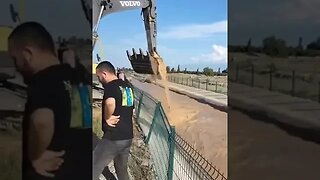 Cow gets scooped up by an excavator