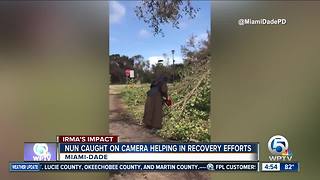 Nun with chainsaw cuts downed tree from Hurricane Irma