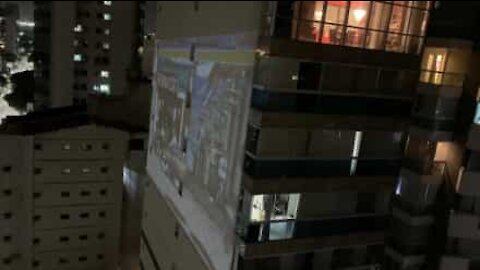 Guy projects video game onto apartment block facade while in quarantine