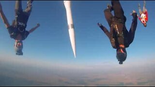Skydivers jump with a missile