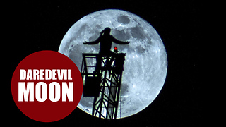 Daredevil teen explorer scaling 70m tower crane to stand in front of supermoon