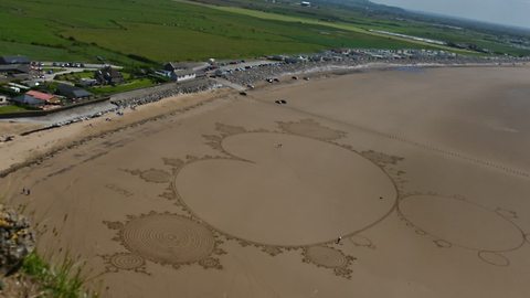 Sand artist uses entire beach to create incredible drawing