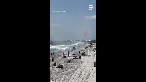 What in the world?” Towels go flying as a dust devil whips across a South Carolina beach.