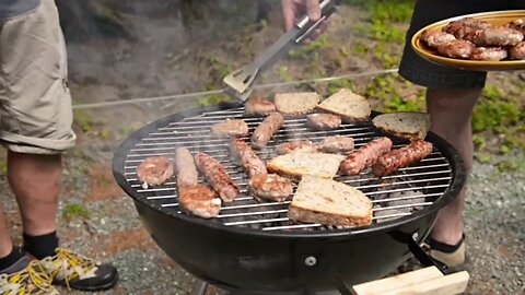 Burger BBQ and some pieces of bread on grill. Some burgers going from grill on plate.