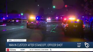 Man in custody after standoff, officer shot