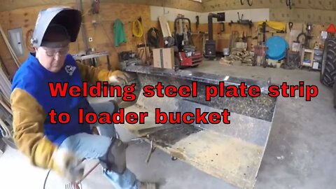 Welding steel plate to loader bucket