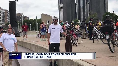 NASCAR champ Jimmie Johnson rides his bike through Detroit for the slow roll