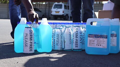 South Africa - Cape Town - Ward Councillor Sonwabile Ngxumza donating hand sanitizers (DA6)