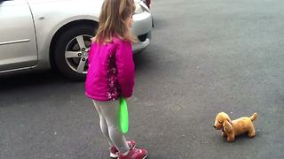 Tot Girl Plays Fetch With Toy Dog