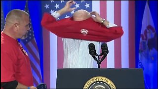 Biden Struggles To Put On A T-shirt