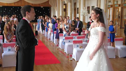 Bride And Groom Sing Duet Down Wedding Aisle