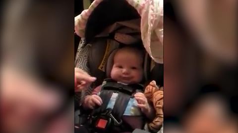 A Baby Boy Makes Funny Faces When His Mom Tightens Up His Baby Seat