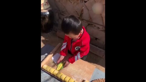 Rural Little Boy Cooking Food All By Himself