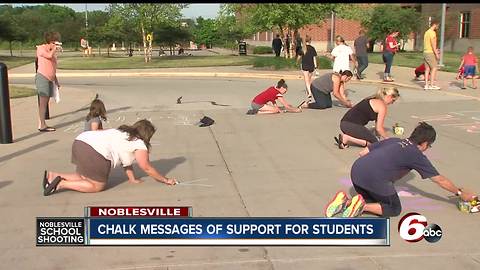 Chalk messages of support written on sidewalks outside Noblesville schools