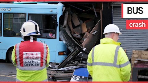 A single-decker school bus had a close shave when it crashed into a barber shop