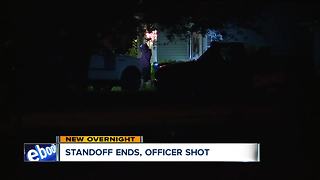 Standoff ends, officer shot