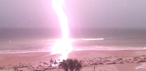 Slow Motion footage Shows moment lightning strikes a beach