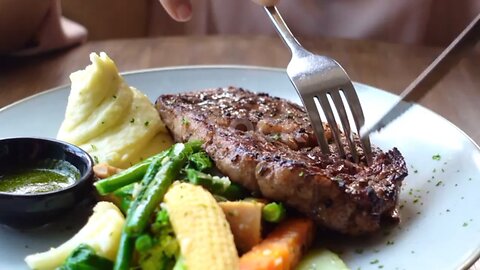 cutting a steak with a knife .