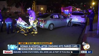 Woman hospitalized after crashing into parked cars