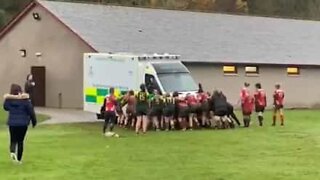 Women's rugby teams join forces to move ambulance