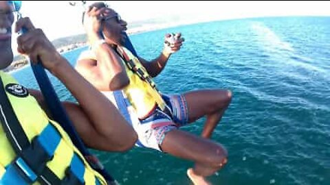 Youth fall in water full of jellyfish while parasailing