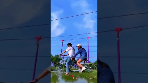 Cute Chinese Girls Get Across A River On A Bicycle