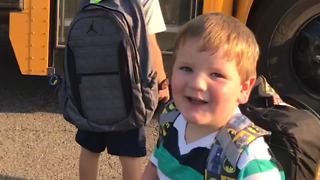 A Little Boy Trips And Falls Off A School Bus