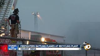 Firefighters working on flames at recycling plant
