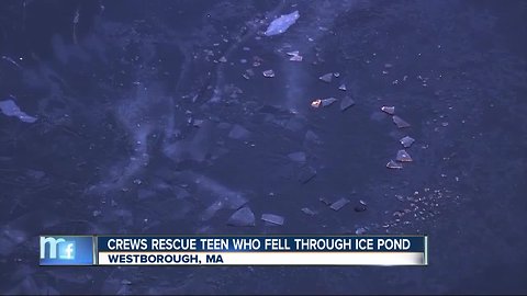 Boy rescued after falling through ice on frozen pond