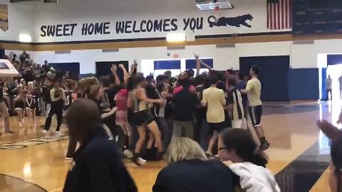 Sweet Home High School teacher sinks a half court shot to help a student