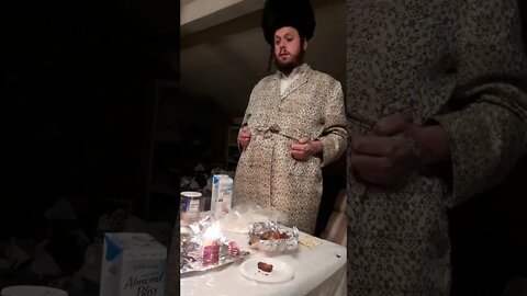 Koblentzer Rebbe burning leftover wicks on Zos Chanukkah