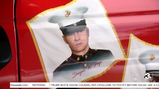A mobile mural honoring 13 fallen marines, including Daegan Page, is unveiled in Omaha