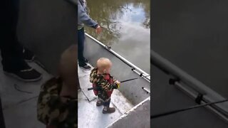 Outdoor Johnny does not want help, boy fishing with Daddy, 2 year old fishing.